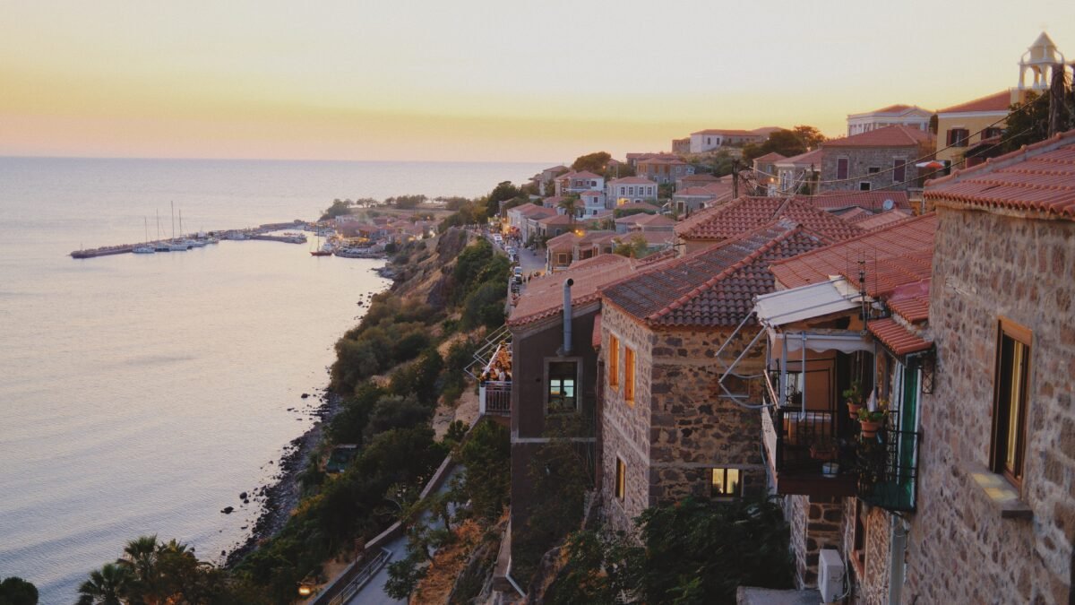 Restaurants with terraces overlooking the harbor in Molyvos, Lesvos, during sunset