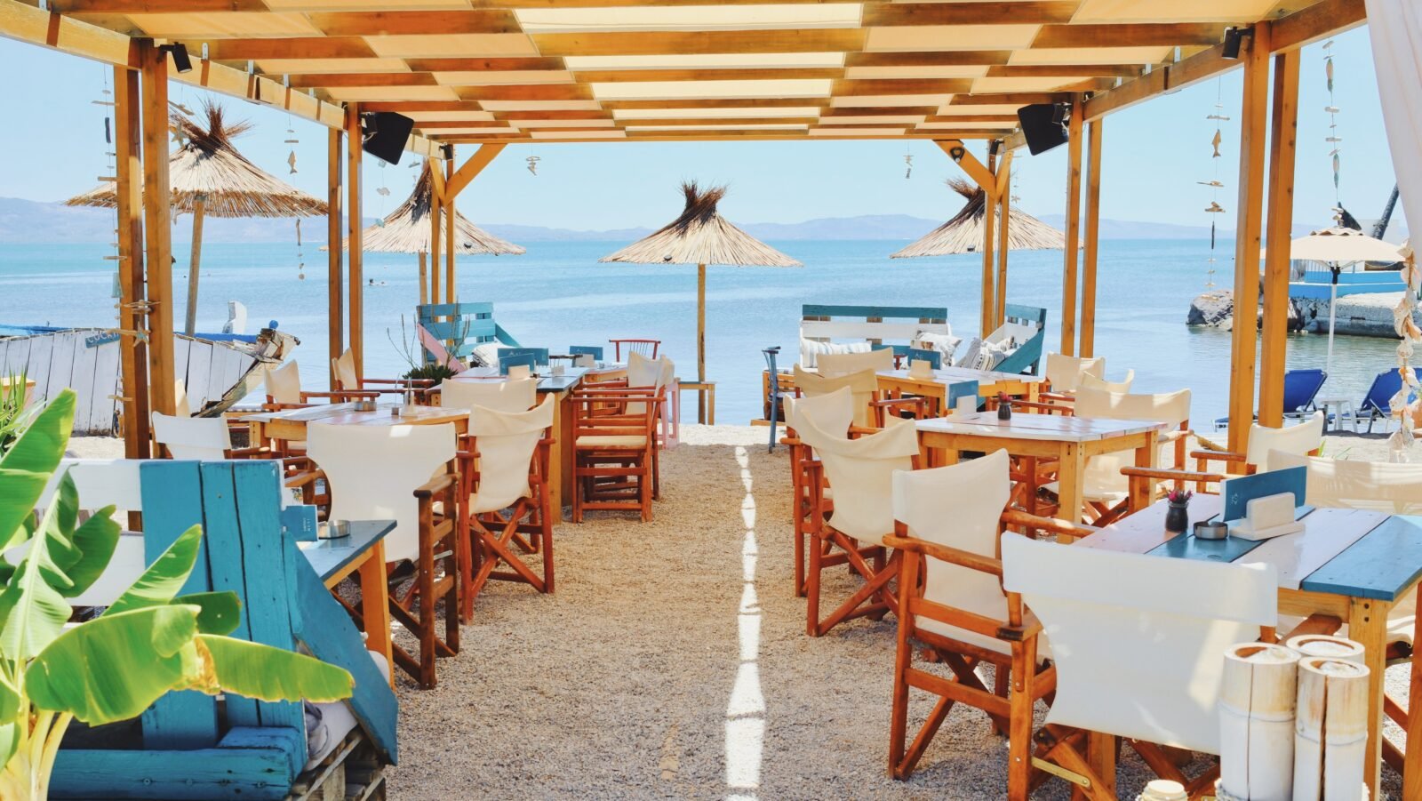 Beachfront restaurant with shaded seating in Skala Kalloni, Lesvos, Greece.