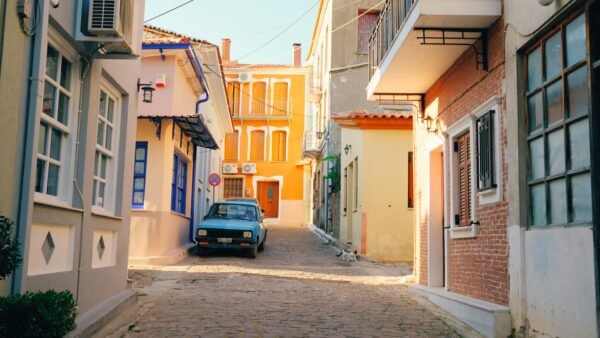 Vintage car parked on a colorful street in Agiasos, Lesvos, Greece.