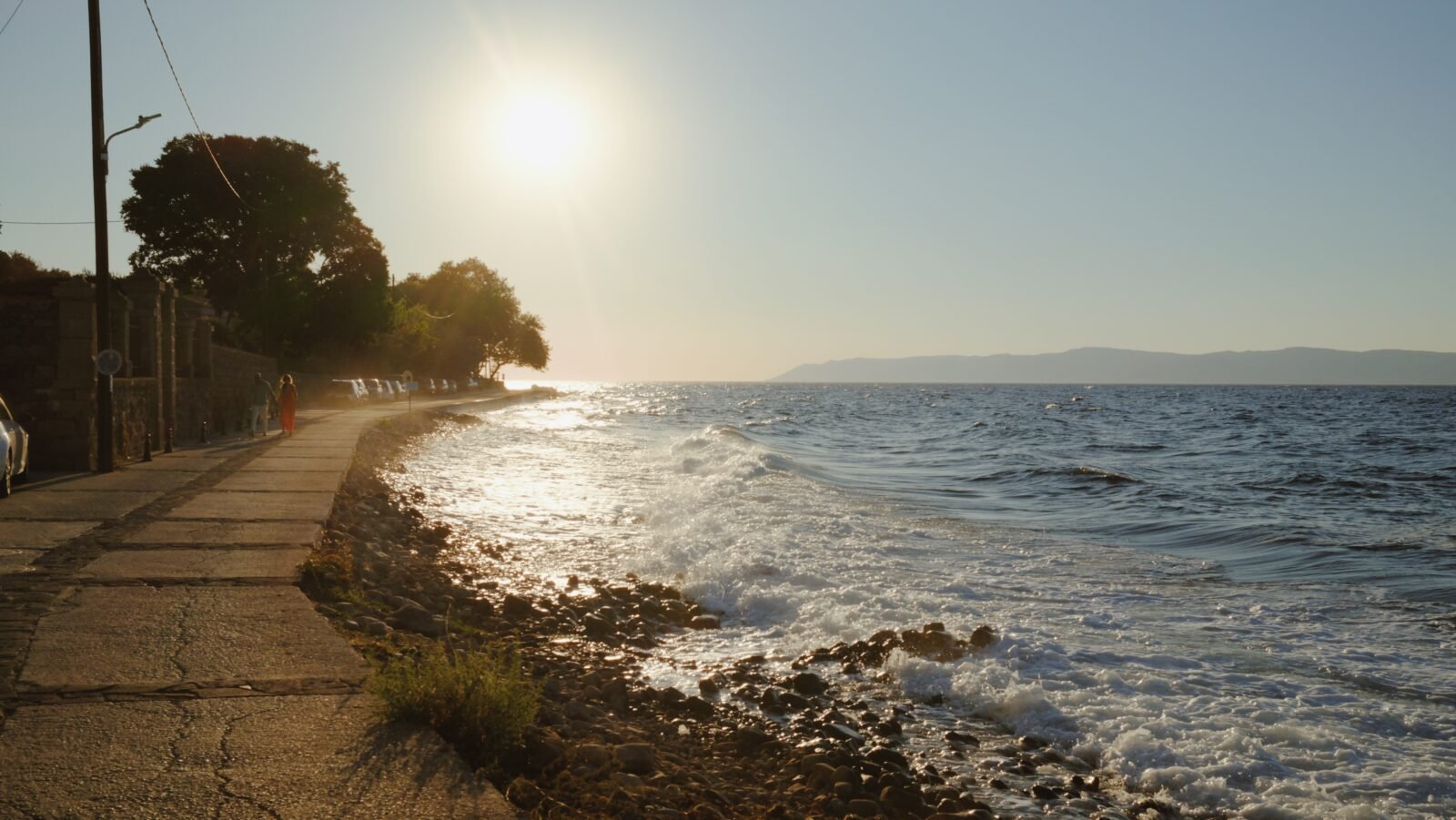 Coastal road at sunset with blue sea
