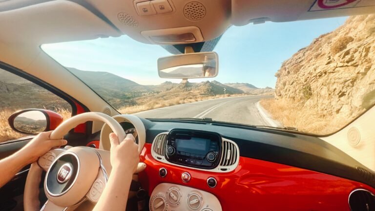 Driving a read fiat convertible car on Lesvos roads