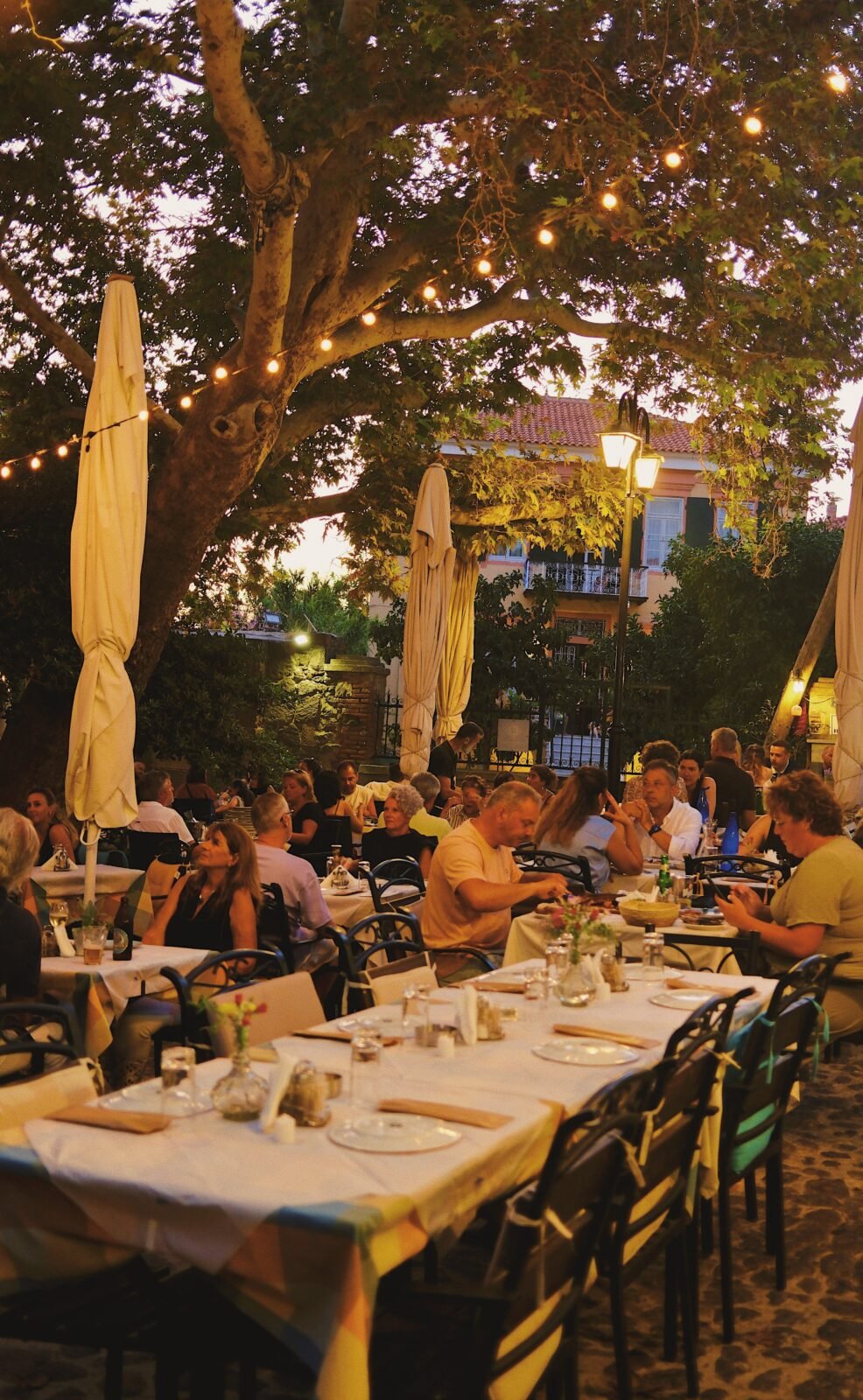 Restaurant square in Molyvos at night with trees decorated with lights