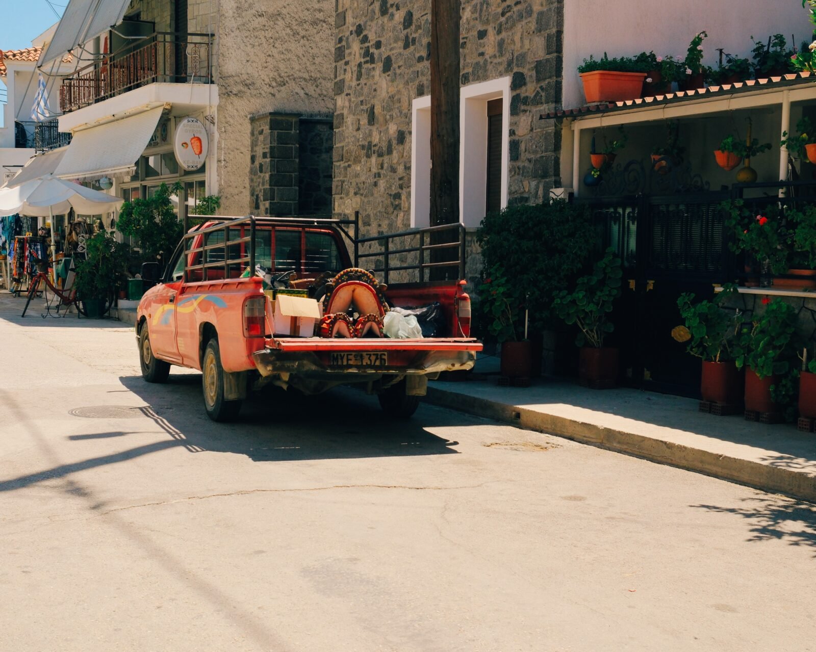 Classic car parked on a quiet street in Skala Kalloni, Greece