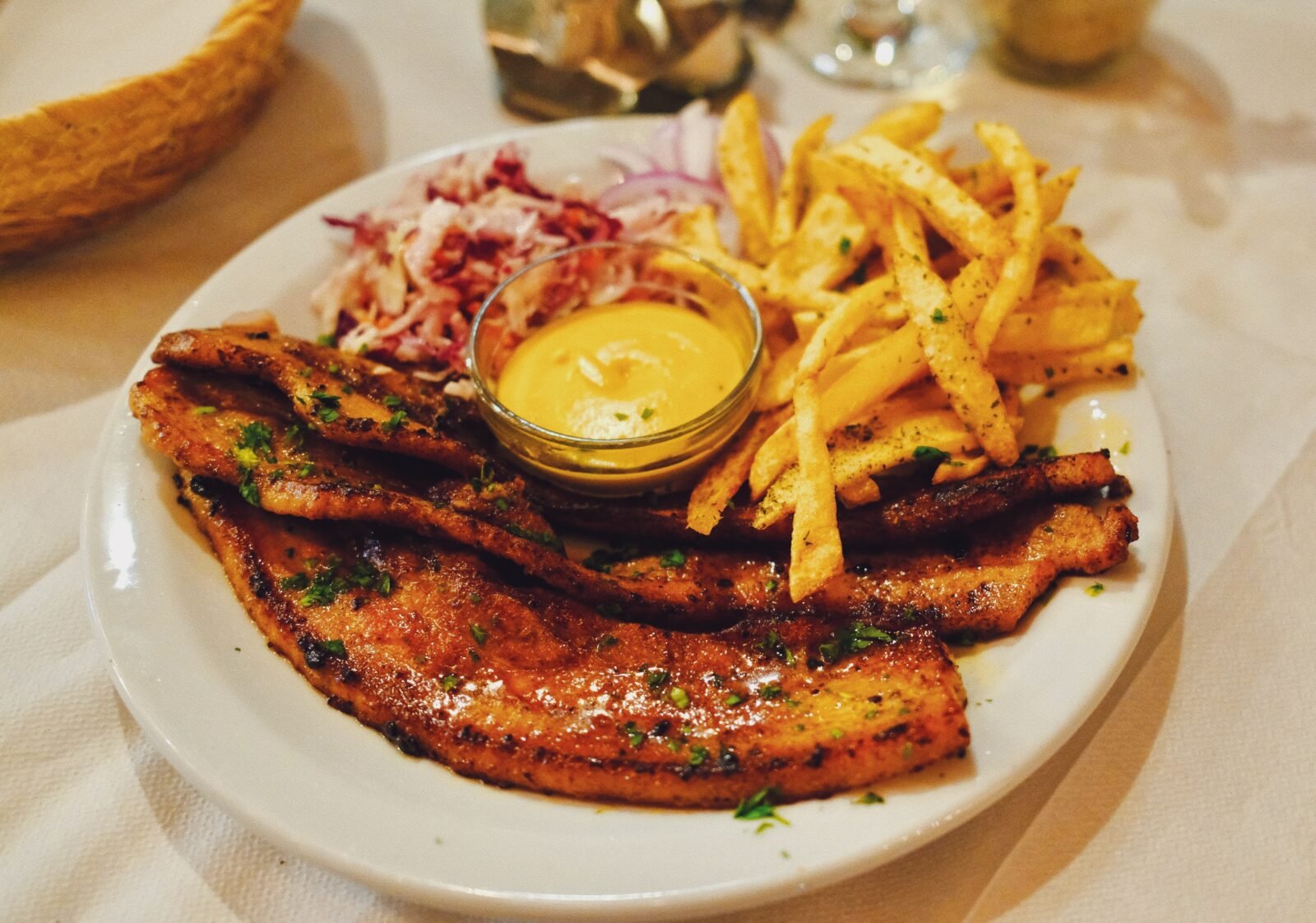 Grilled pork fillet strips with fries, coleslaw and mustard dip at a taverna in Molyvos, Lesvos