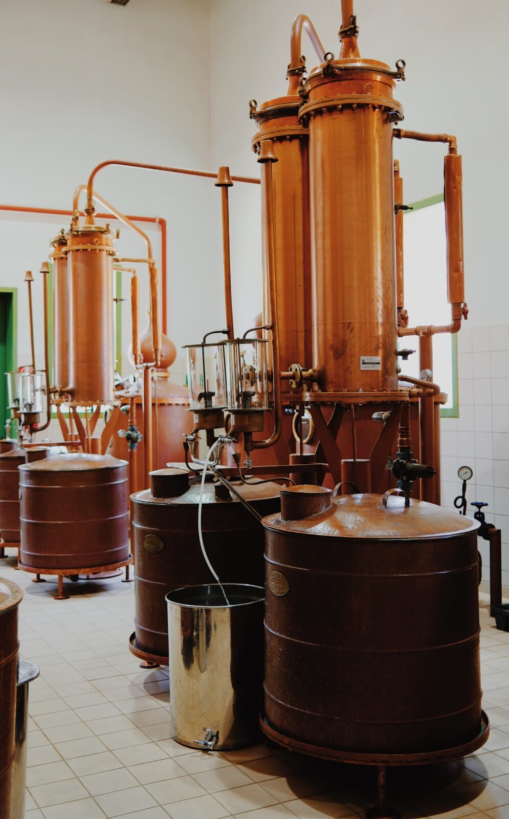 Row of traditional copper stills used for ouzo distillation at Ouzo of Plomari, Lesvos